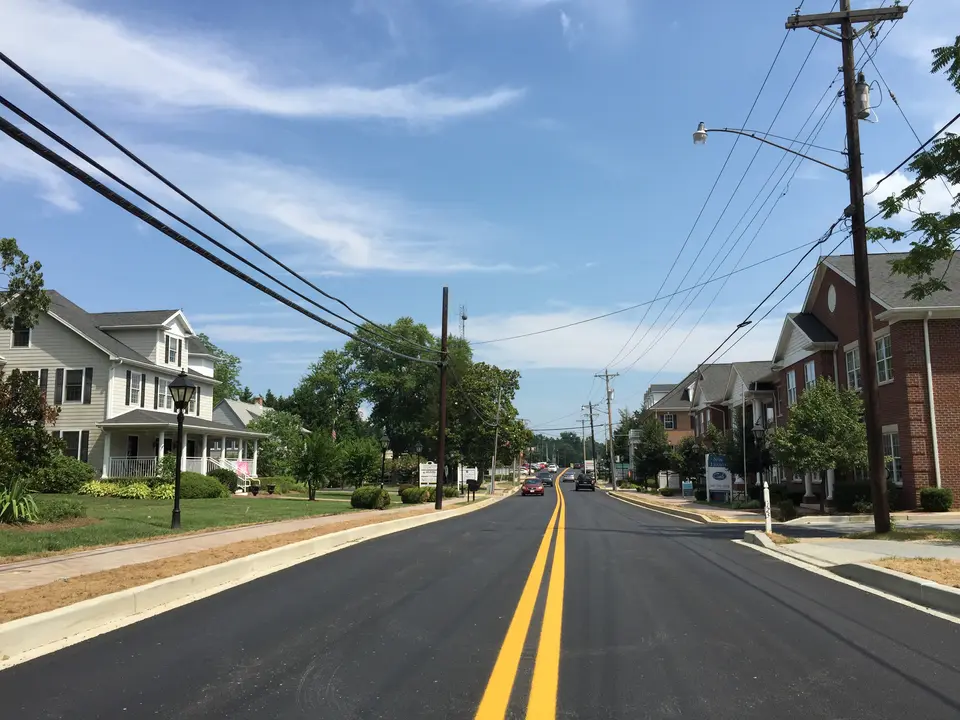 Main Street in Prince Frederick, the county seat, lined with homes and shade trees on a sunny day.